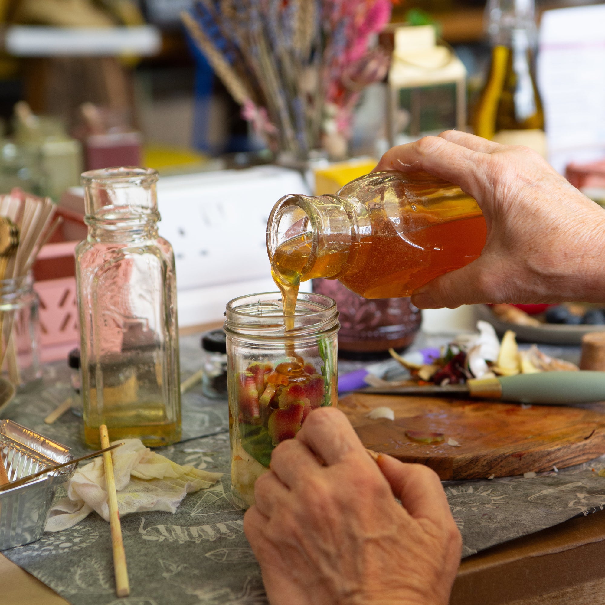 making an oxymel, pouring honey into a jar