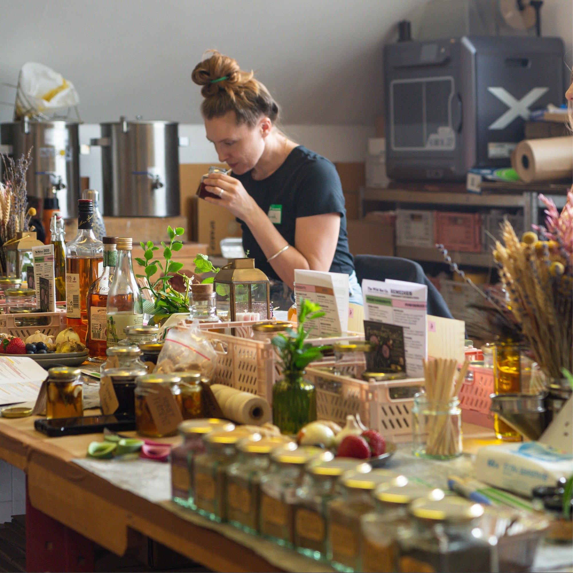 a person making remedies inspired by bees, honey and propolis. The Wild Bee studio in Surrey during a bee remedies workshop.