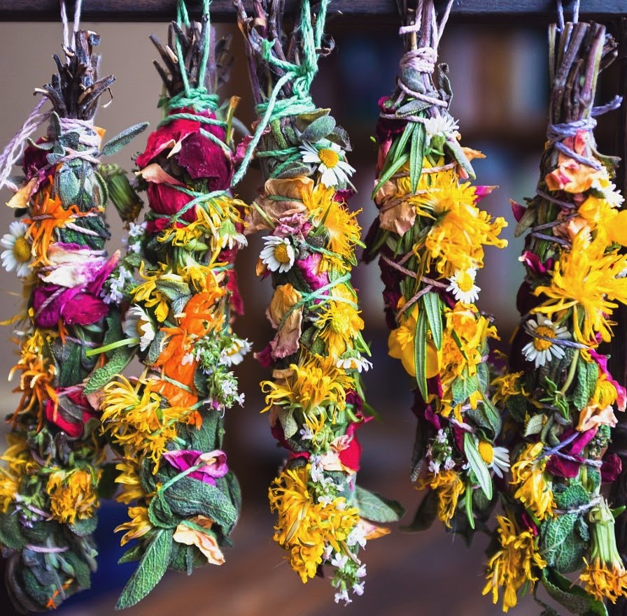 Handmade sage bundles hanging, inspired by the magic of bees